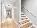 Bright hallway featuring hardwood floors, neutral walls, staircase, and ample natural light at 303 Applecross Dr, Cary, NC 27511