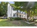 Inviting two-story home featuring a covered front porch, white siding, and a well-manicured lawn at 3421 Tunas St, Raleigh, NC 27616