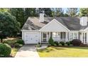 Inviting single-story home with a welcoming front porch, lush landscaping, and an attached garage at 3782 Loblolly Dr # 5, Rocky Mount, NC 27804