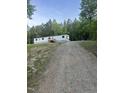 Gravel driveway leads up to the white house surrounded by trees at 4025 Royal Dr, Franklinton, NC 27525