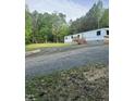 Gravel area with forest and limited lawn in the background at 4025 Royal Dr, Franklinton, NC 27525