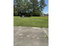 Large open backyard featuring an outbuilding and mature shade trees at 410 Carmil Dr, Selma, NC 27576