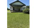Rear of home features a covered area perfect for outdoor living at 410 Carmil Dr, Selma, NC 27576