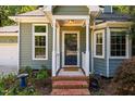 Charming front door with brick steps and small garden at 4117 Olde Coach Rd, Durham, NC 27707