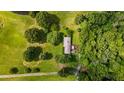 Aerial view of a home on expansive lot surrounded by mature trees and greenery at 4345 Mcintyre Rd, Gibsonville, NC 27249