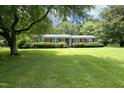 Well-maintained front yard with mature trees and bushes in front of the brick home at 4345 Mcintyre Rd, Gibsonville, NC 27249