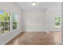 Bright Living Room with hard wood floors and windows overlooking the lawn at 4716 Miller Dr, Durham, NC 27704