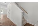 Carpeted staircase in a house with hardwood floors and white walls at 4716 Miller Dr, Durham, NC 27704