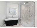 Modern bathroom featuring a freestanding tub and a glass-enclosed shower with elegant tile work at 509 Colleton Rd, Raleigh, NC 27610