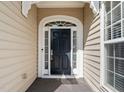 Close up of the beautiful black front door with sidelights and an arched transom window at 621 Aylestone Dr, Cary, NC 27519