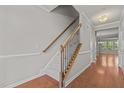Inviting entryway featuring hardwood floors, a staircase with decorative iron railings, and neutral paint at 8323 Yaxley Hall Dr, Raleigh, NC 27616