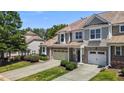 A townhouse showcasing its exterior with brick accents, complemented by a well-manicured lawn at 8323 Yaxley Hall Dr, Raleigh, NC 27616