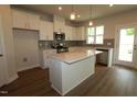 New kitchen features granite countertops, stainless appliances, and new wood flooring at 912 Montague Ave, Durham, NC 27703