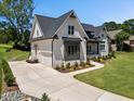 Beautiful house with a concrete driveway, landscaped yard and painted brick exterior at 940 Rivers Edge Dr, Graham, NC 27253