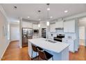 Bright kitchen featuring stainless steel appliances, a center island, and ample cabinet space at 1004 Sounding Ln, Durham, NC 27703