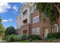 Multi-level exterior featuring brick and siding architecture, with a welcoming entrance and lush greenery at 108-203 Northbrook Dr # 203, Raleigh, NC 27609