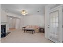 Bright living room featuring a fireplace, neutral carpeting, and an outdoor access door at 108-203 Northbrook Dr # 203, Raleigh, NC 27609