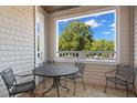 Cozy covered porch with table and chairs, perfect for outdoor dining and relaxation at 108-203 Northbrook Dr # 203, Raleigh, NC 27609