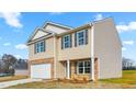 Two-story home featuring a brick and vinyl exterior with gray shutters, front entry columns, and a concrete driveway at 119 Leven Dr, Gibsonville, NC 27249