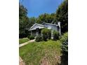 Quaint single-story home surrounded by lush greenery and mature trees, offering a private setting at 1305 E Jones St, Raleigh, NC 27610
