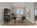 Dining room with stylish decor, a modern light fixture, and views of the outdoors at 1400 Gathering Park Cir # 203, Cary, NC 27519