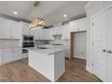 Modern kitchen featuring white cabinets, quartz countertops, stainless steel appliances, and wood floors at 1400 Gathering Park Cir # 203, Cary, NC 27519