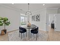 Dining area showcasing a round table with stylish chairs and modern artwork on the wall at 1400 Gathering Park Cir # 301, Cary, NC 27519
