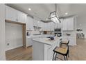 Bright, modern kitchen with white cabinets, a center island with seating, and a stylish chandelier at 1400 Gathering Park Cir # 301, Cary, NC 27519