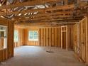 Unfinished room featuring exposed framing, windows, and wiring in a new construction home at 171 Surles Landing Way, Benson, NC 27504