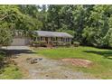 This single-story home boasts a well-maintained lawn, a brick pathway, and an inviting exterior at 18 Red Pine Rd, Chapel Hill, NC 27516