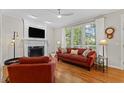 Inviting living room with fireplace, large windows, and comfortable seating at 208 Holly Green Ln, Holly Springs, NC 27540
