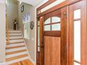 Welcoming entryway with a wooden front door and staircase at 30 Cole Creek Way, Franklinton, NC 27525