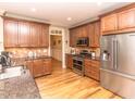 Kitchen featuring stainless steel appliances, granite countertops, and wooden cabinets at 30 Cole Creek Way, Franklinton, NC 27525