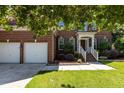 Classic brick home with a two-car garage, beautiful landscaping, and inviting front entrance at 308 Sutton Glen Dr, Apex, NC 27523