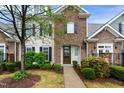 Beautiful townhome with stone accents and a well-maintained front yard with lush greenery at 4203 Overcup Oak Ln, Cary, NC 27519