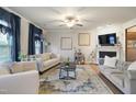 Inviting living room featuring hardwood floors, a fireplace, and comfortable seating at 4203 Overcup Oak Ln, Cary, NC 27519