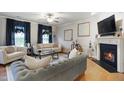 Inviting living room featuring hardwood floors, a fireplace, and comfortable seating at 4203 Overcup Oak Ln, Cary, NC 27519