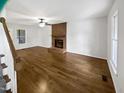 The spacious living room offers a brick fireplace and hardwood floors at 5356 Baywood Forest Dr, Knightdale, NC 27545
