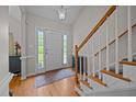 Welcoming foyer with hardwood floors, staircase with white railing, and ample natural light at 545 Olivia Way, Selma, NC 27576
