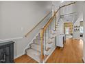 Carpeted staircase featuring wood railing and white spindles leading to an upper level at 545 Olivia Way, Selma, NC 27576