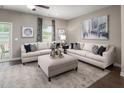 Bright living room with neutral tones, cozy seating, and contemporary decor at 601 Rockwater Path, Durham, NC 27713