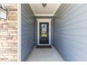 Stylish front door with glass pane and a 'welcome' mat leading into the home at 705 Churton Pl, Cary, NC 27518