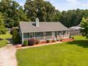 Inviting ranch-style home featuring a covered front porch and a well-maintained lawn at 73 Richmond Dr, Archer Lodge, NC 27527