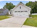 View of a two car garage with white doors, set against the home's light gray facade at 100 Haddonfield Ct, Franklinton, NC 27525