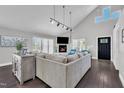 Bright living room with a fireplace, dark wood floors, and a comfortable sofa under vaulted ceilings at 101 Ferndale Ct, Clayton, NC 27520