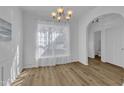Bright, spacious dining room with wood-look floors, modern lighting, and an open archway at 11309 Shadow Elms Ln, Raleigh, NC 27614