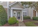 Inviting front entrance with a decorative door and manicured landscaping creates excellent curb appeal at 11309 Shadow Elms Ln, Raleigh, NC 27614