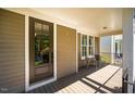 Cozy front porch features a stylish seating area, perfect for enjoying the neighborhood views at 1168 Great Ridge Pkwy, Chapel Hill, NC 27516