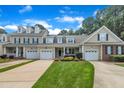 An inviting townhome features an attached garage, a front lawn, and a driveway at 1326 Fairview Club Dr, Wake Forest, NC 27587