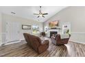 Inviting living room featuring a fireplace, wood floors, neutral paint, and plenty of natural light at 172 Fox Run Ct, Benson, NC 27504